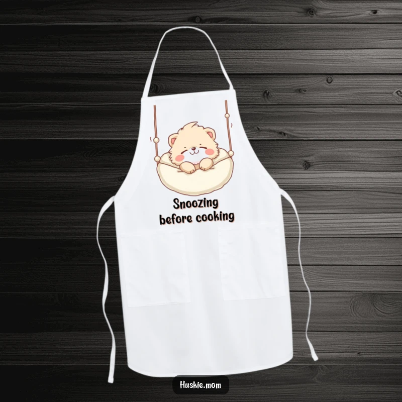 Funny Apron: A cute fluffy animal with a playful grin sleeping soundly in a suspended bed, perfect for relaxed cooking.