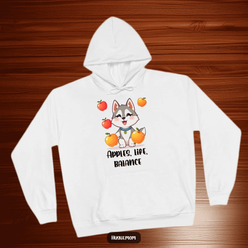Funny hoodie depicting a determined Husky lady animal struggling humorously while juggling three shiny apples.