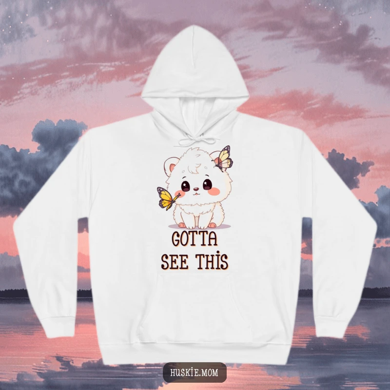 Funny hoodie showcasing a fluffy animal's curious gaze fixed on a butterfly, perfect for cozying up with whimsical charm.