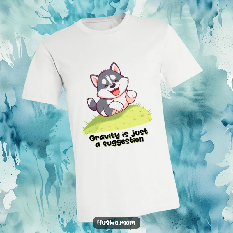 Funny t-shirt with a gleeful husky puppy tumbling head over paws down a grassy hill, showcasing pure joy and playfulness.