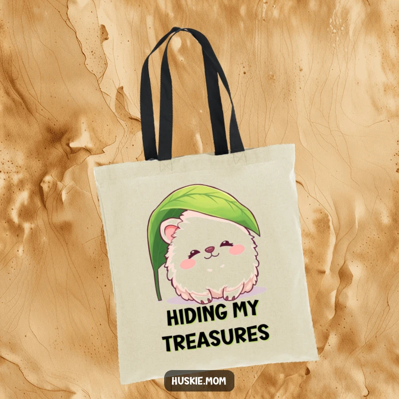Funny fluffy animal tote bag with a creature peacefully smiling and peeking from under a leaf, perfect for gentle, humorous style.